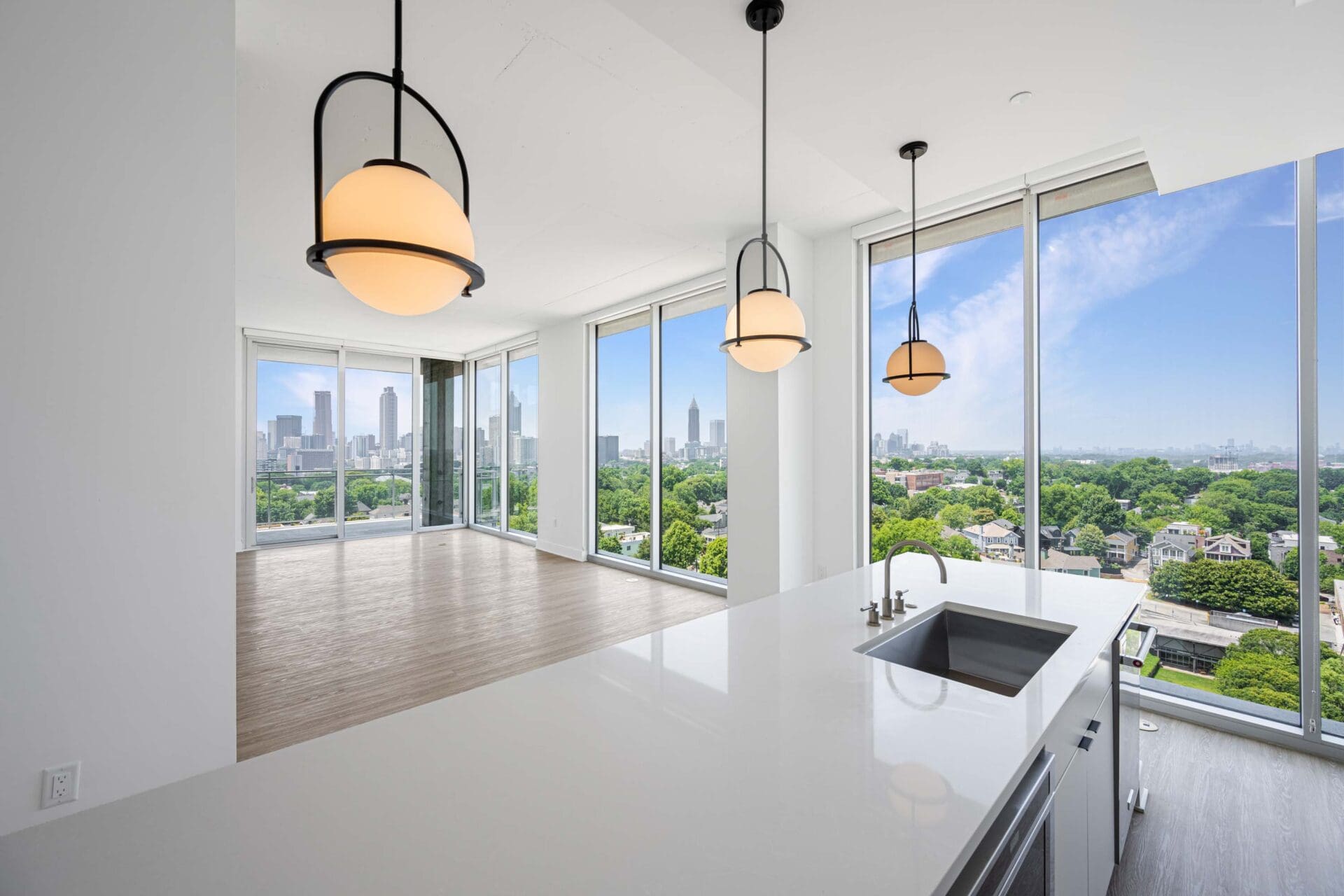 Modern kitchen with city view and lights.