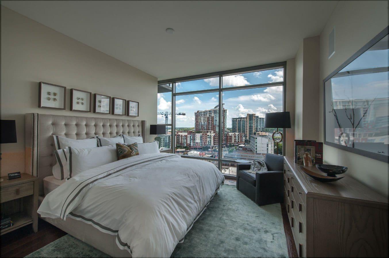Modern bedroom with city view and decor.