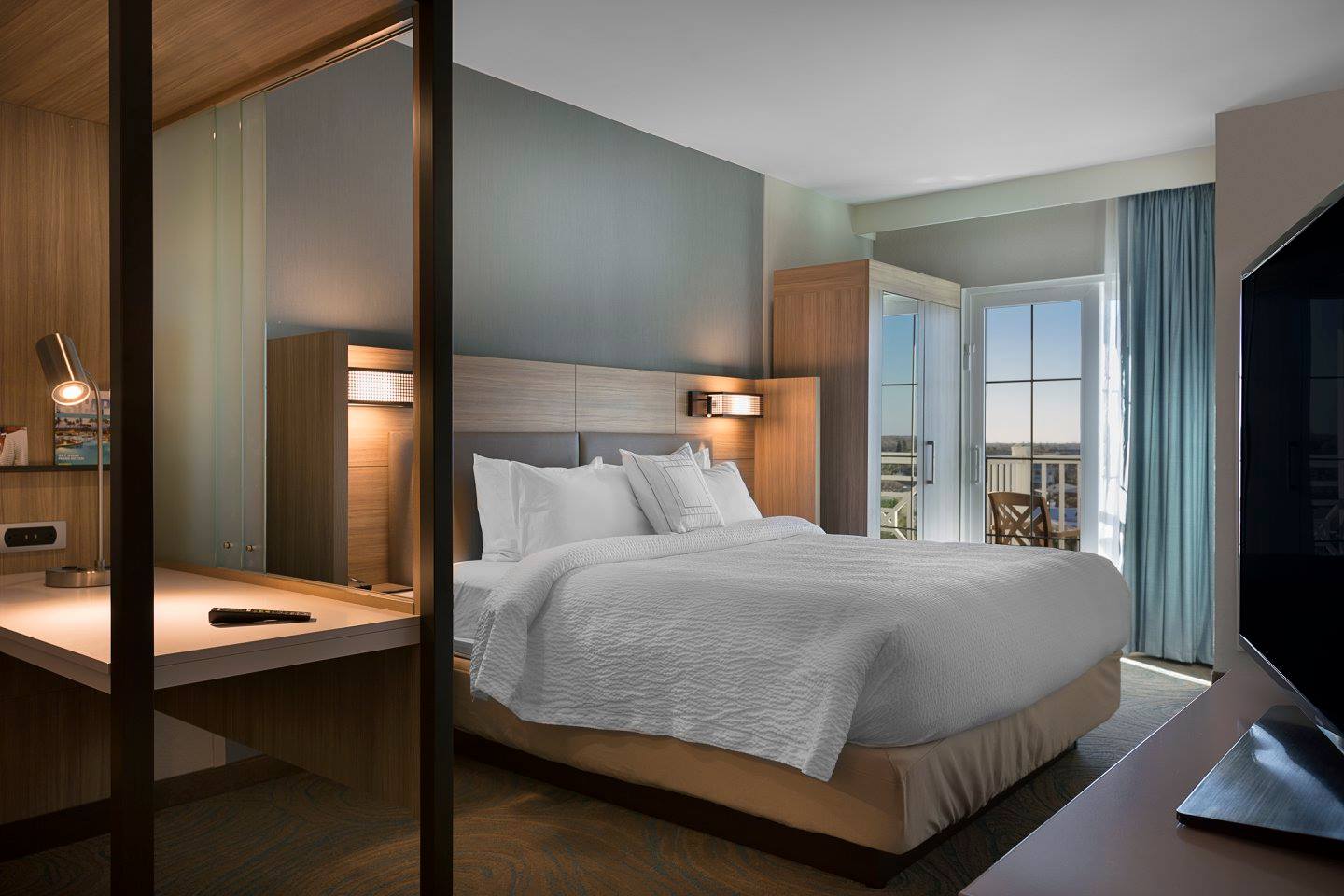 Modern hotel room with a balcony view.