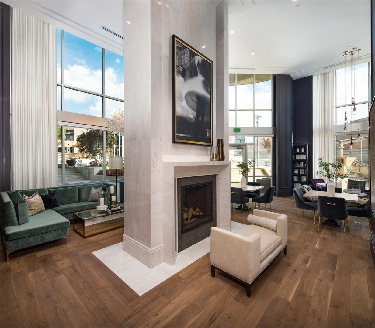 Modern living room with large windows and fireplace.