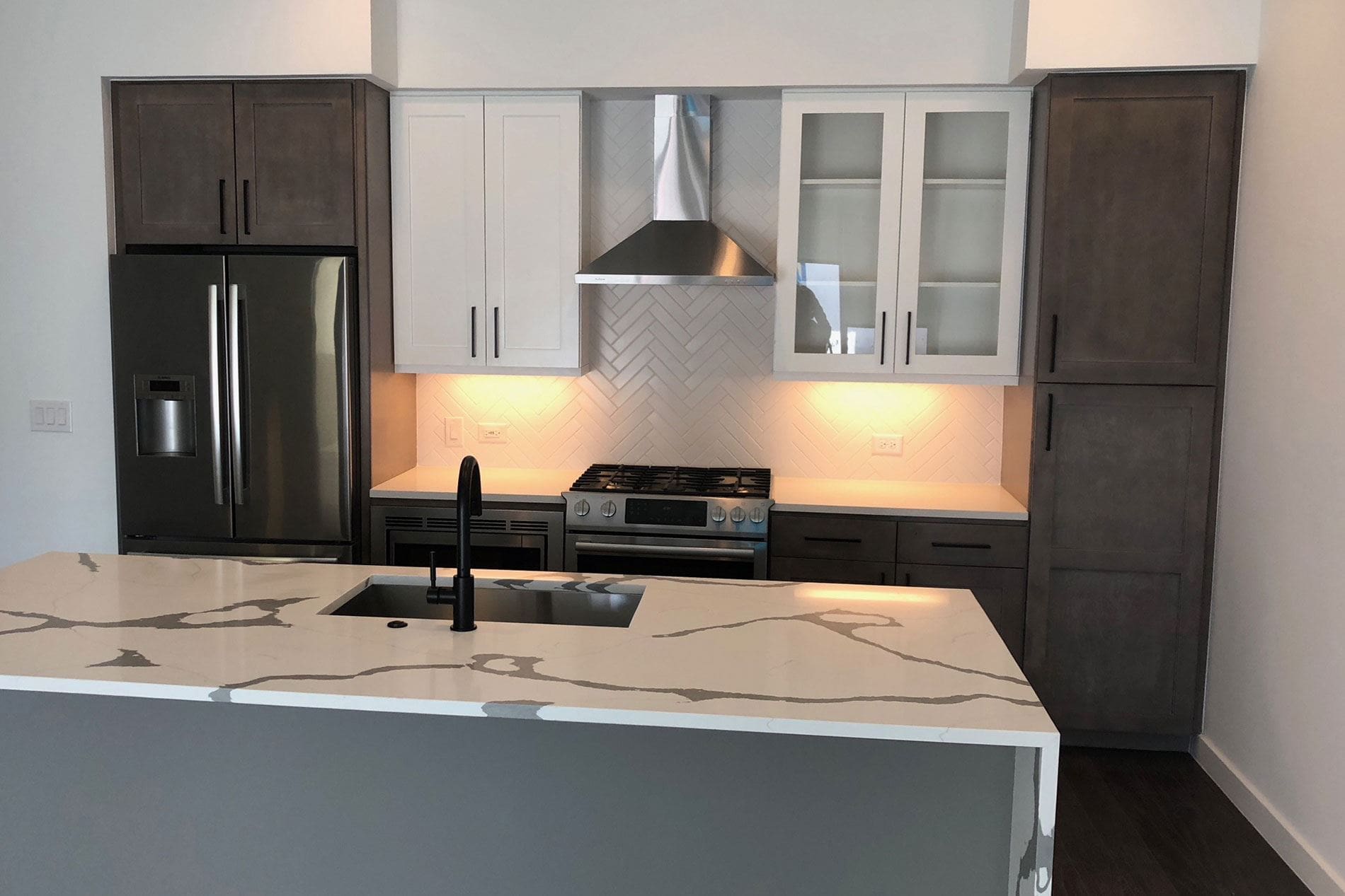 Modern kitchen with marble island and stainless appliances