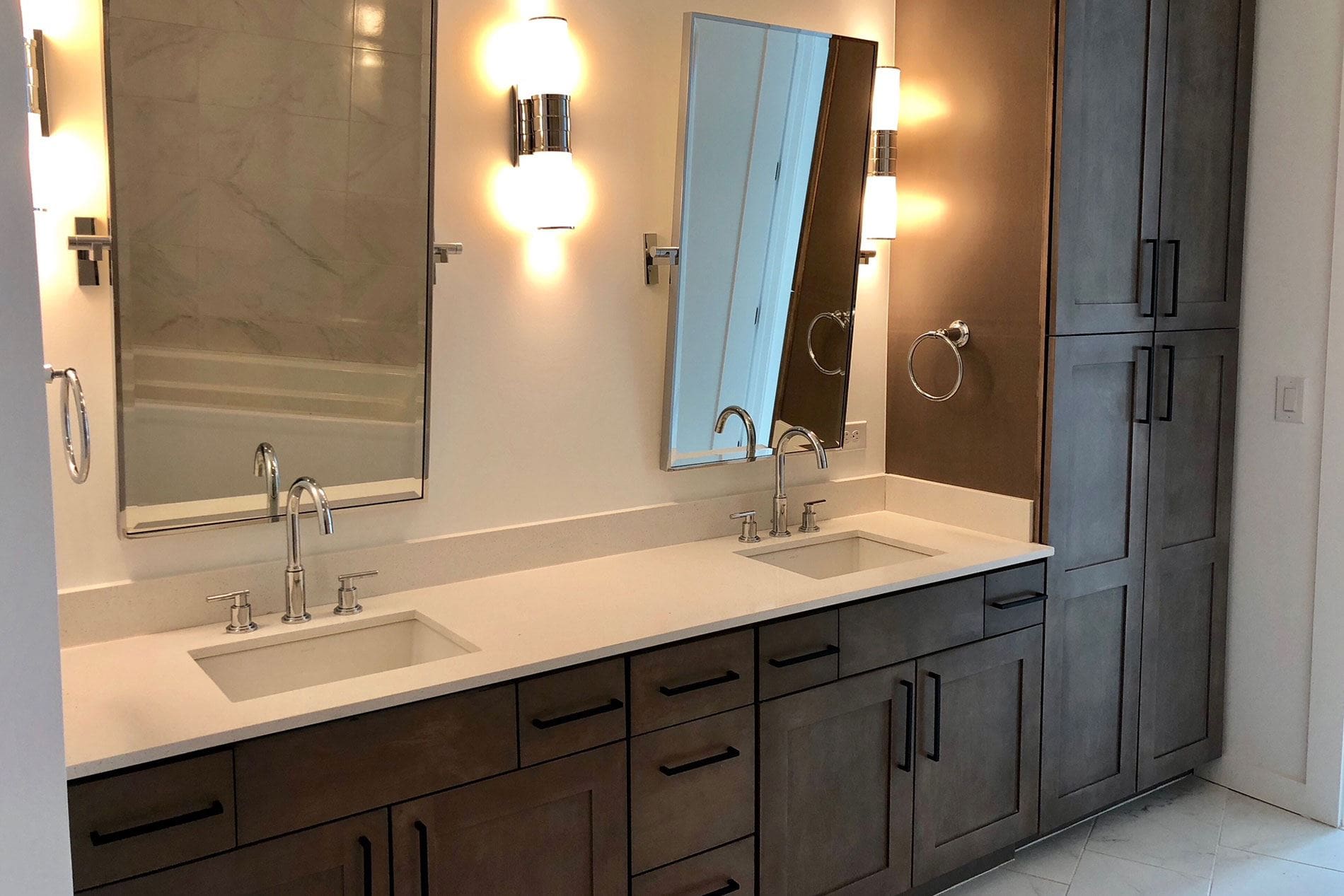 Modern bathroom with dual sinks and mirrors.