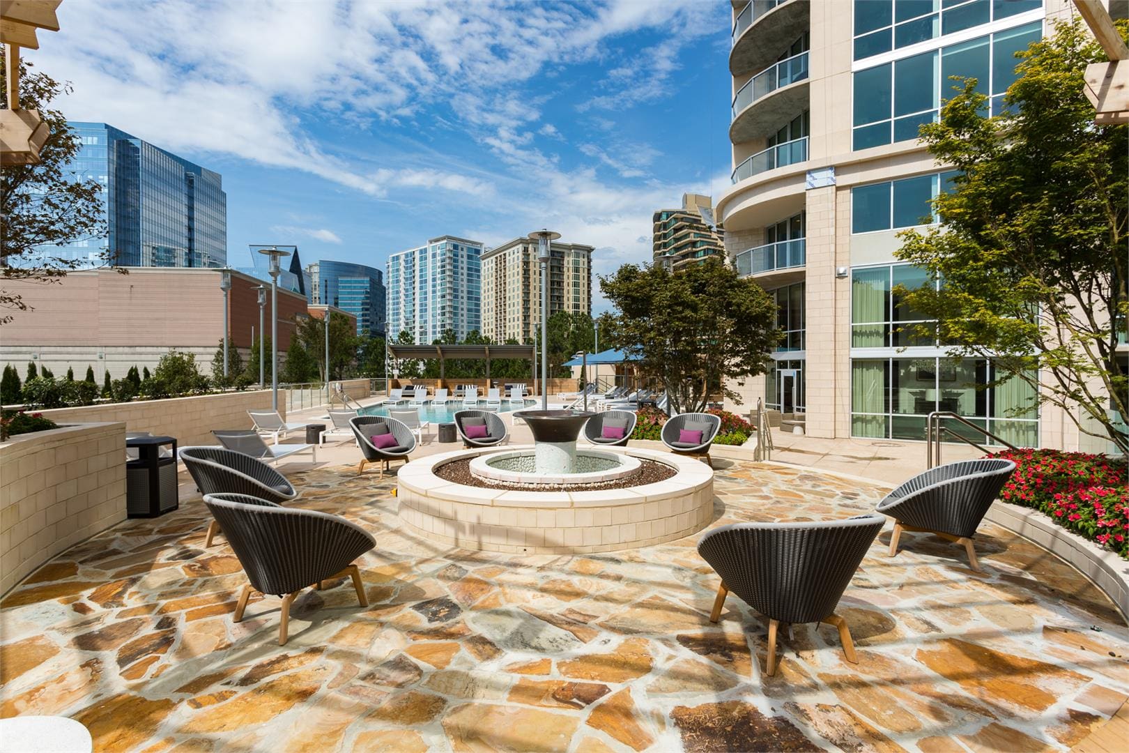 Outdoor patio with chairs and city view.
