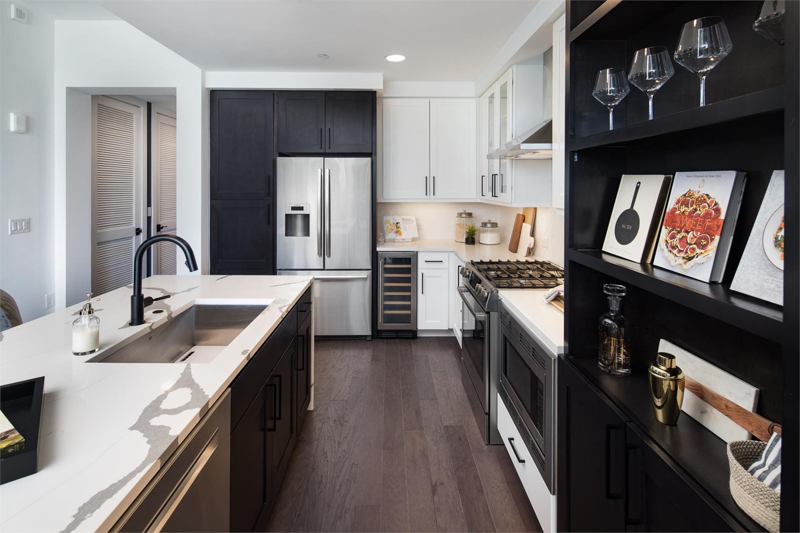 Modern kitchen with sleek black and white design.