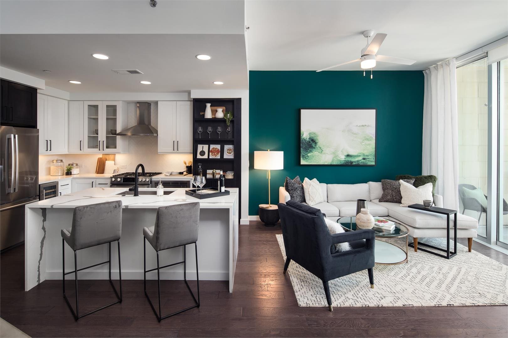 Open-plan kitchen and living room with teal wall