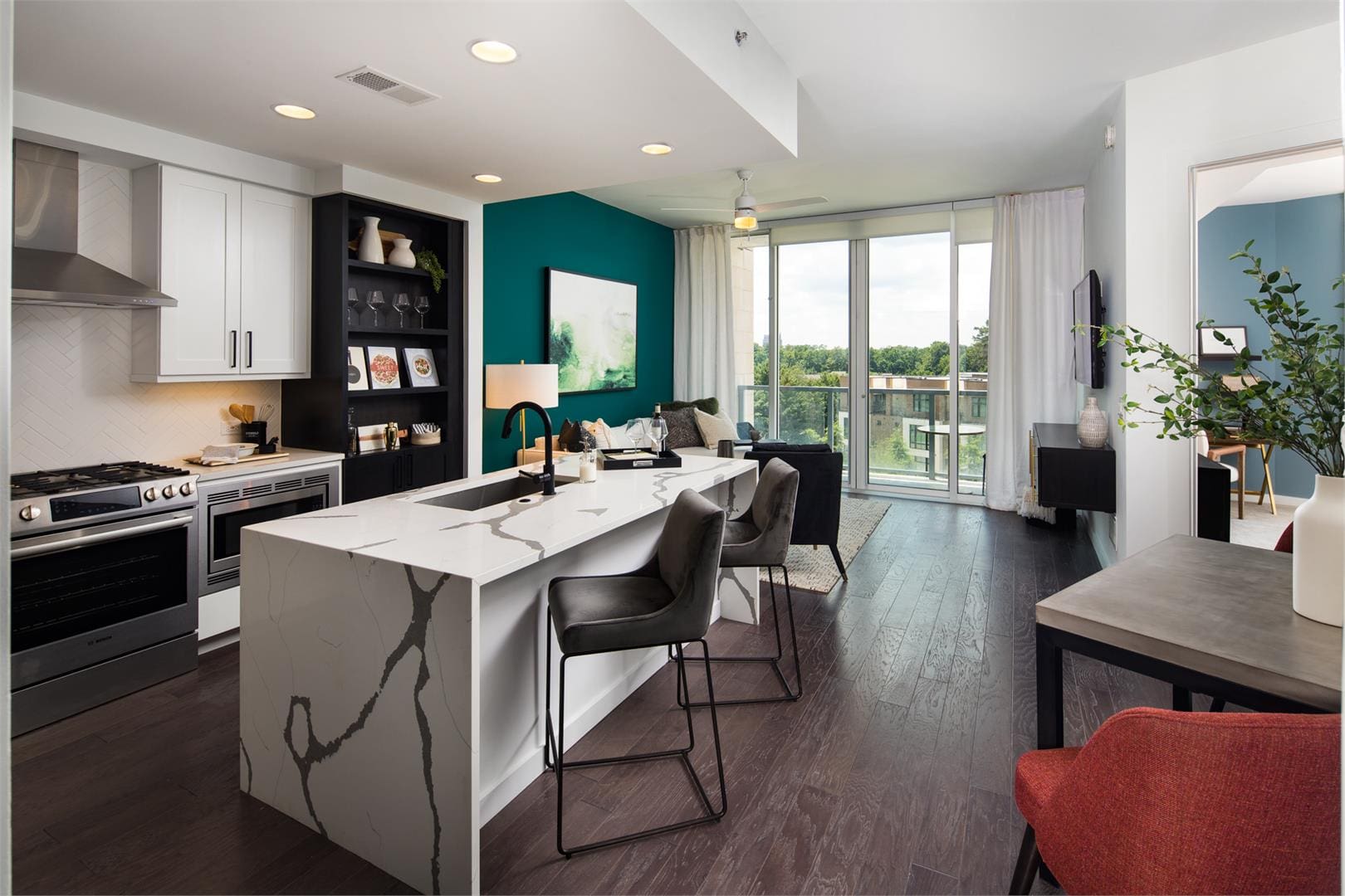 Modern apartment kitchen with marble island and balcony