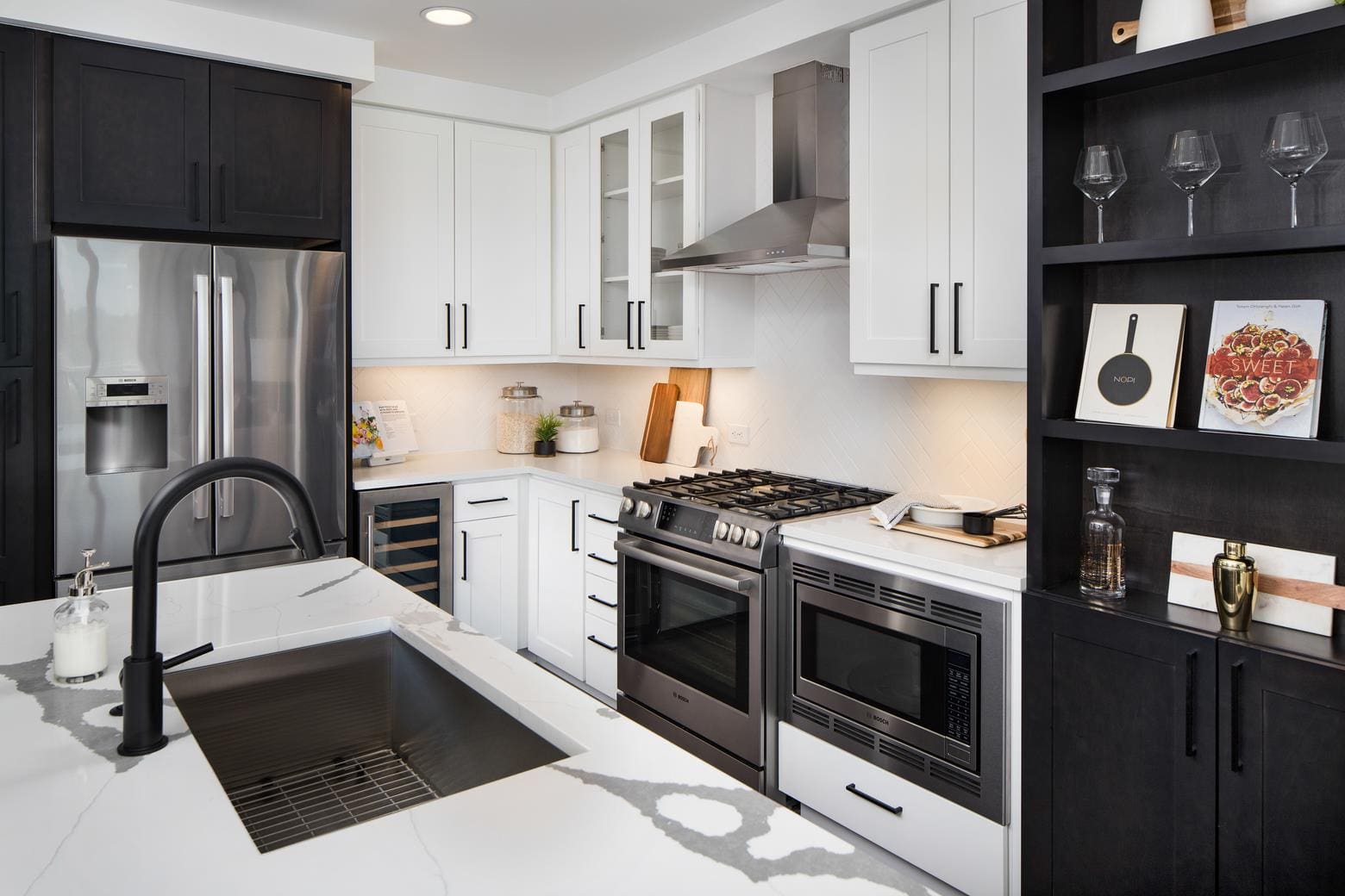 Modern kitchen with black and white cabinetry.