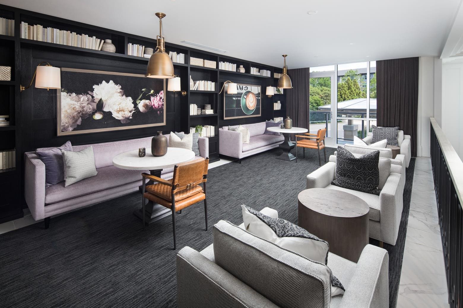 Modern lounge with sofas and bookshelves.