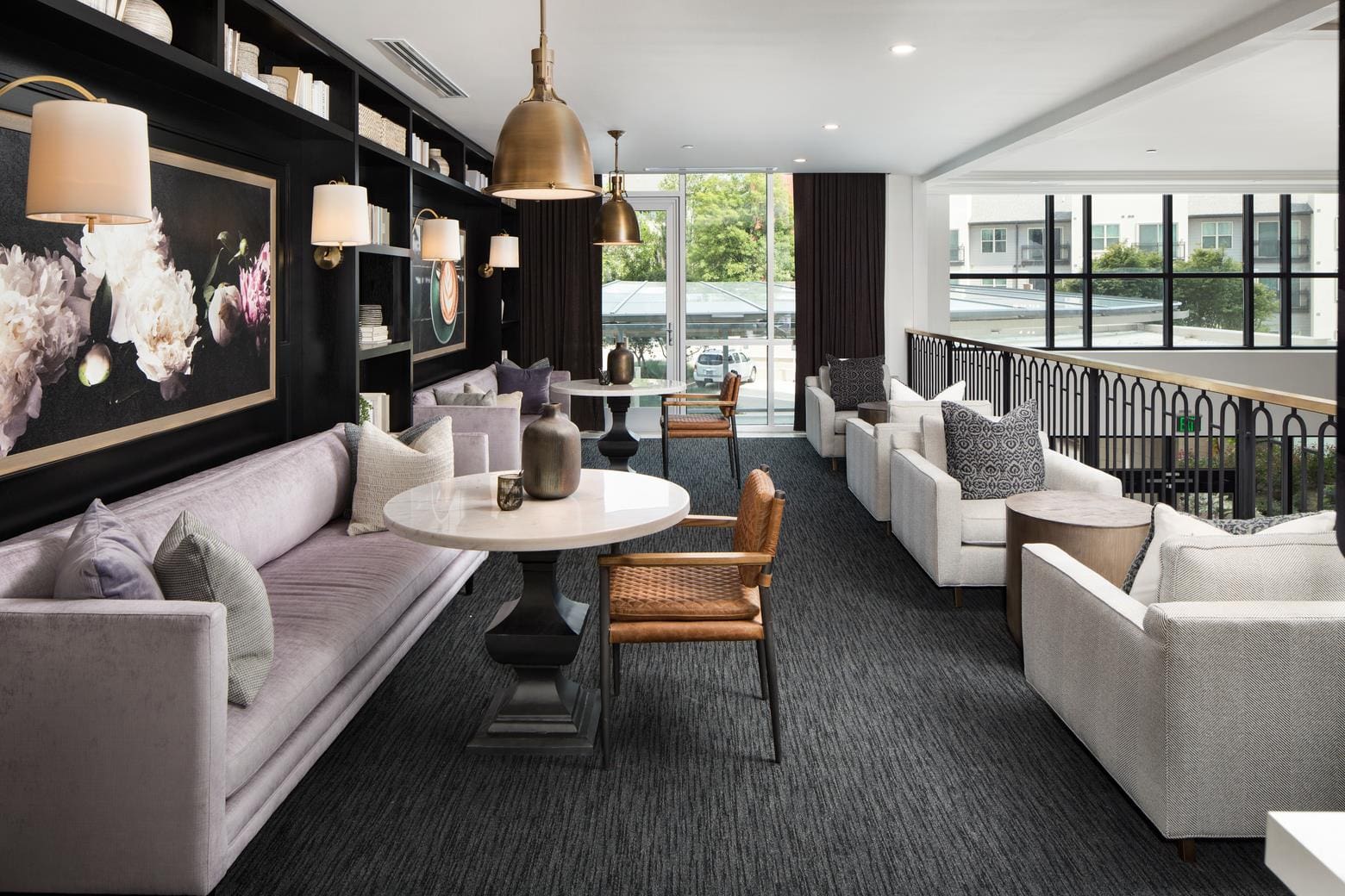 Modern lounge with seating and decorative lighting.