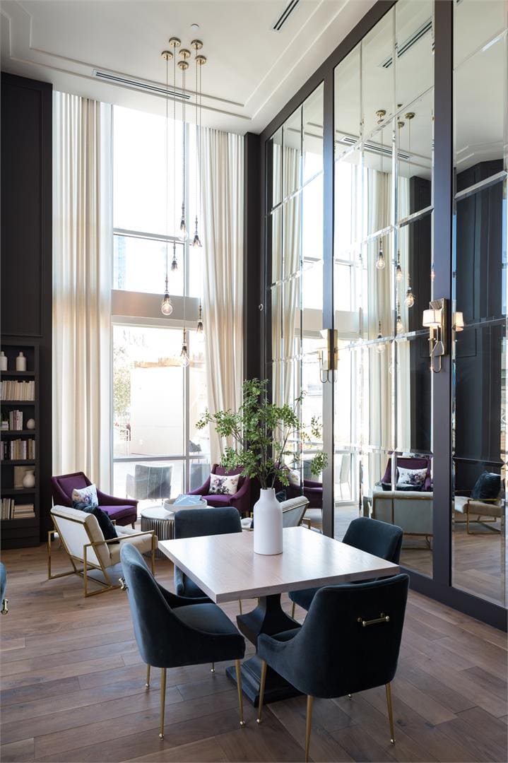 Modern dining area with large mirrors.