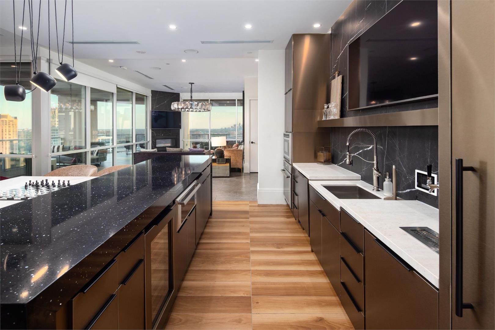 Modern kitchen with sleek black countertops and island.
