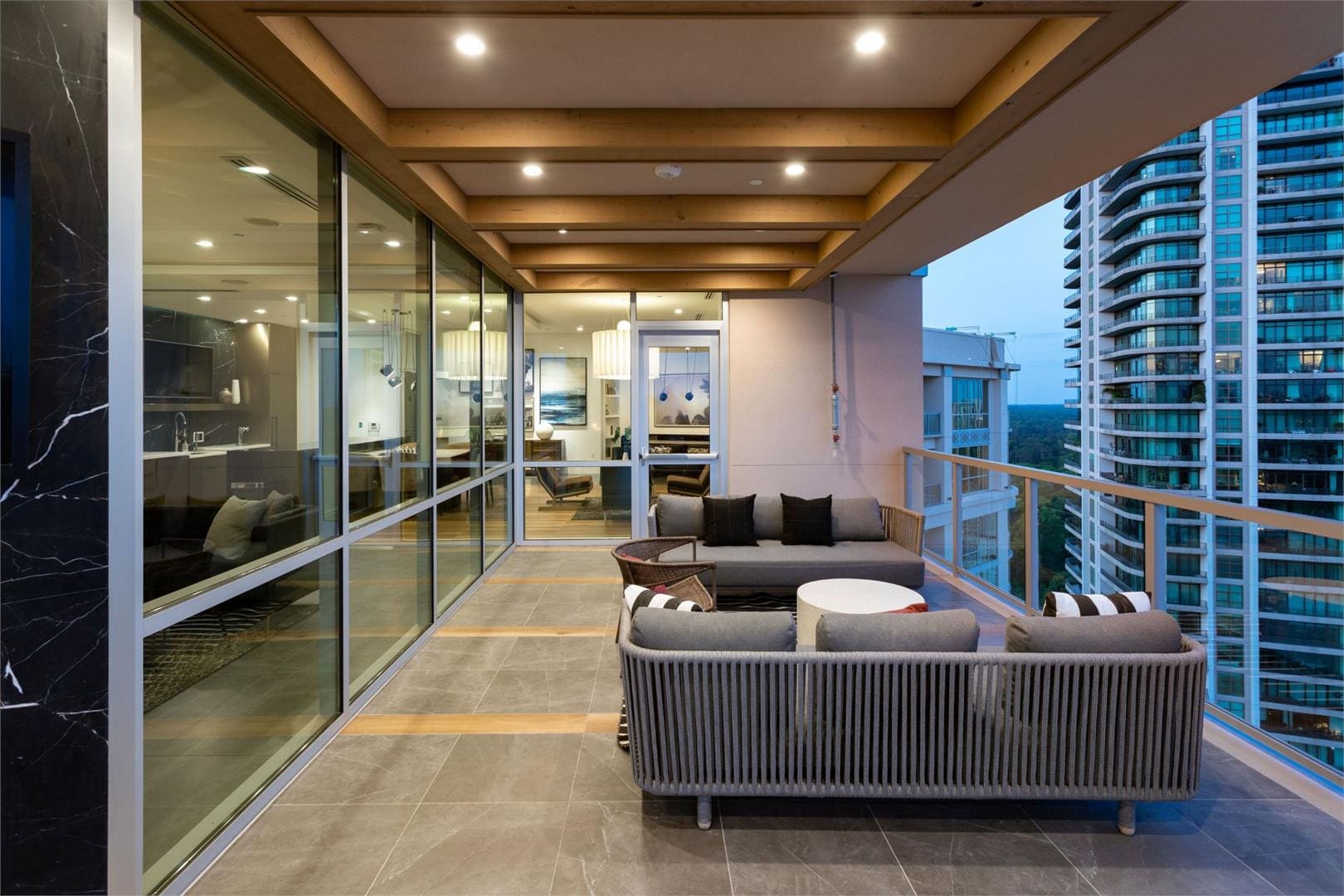Modern balcony with seating and city view.