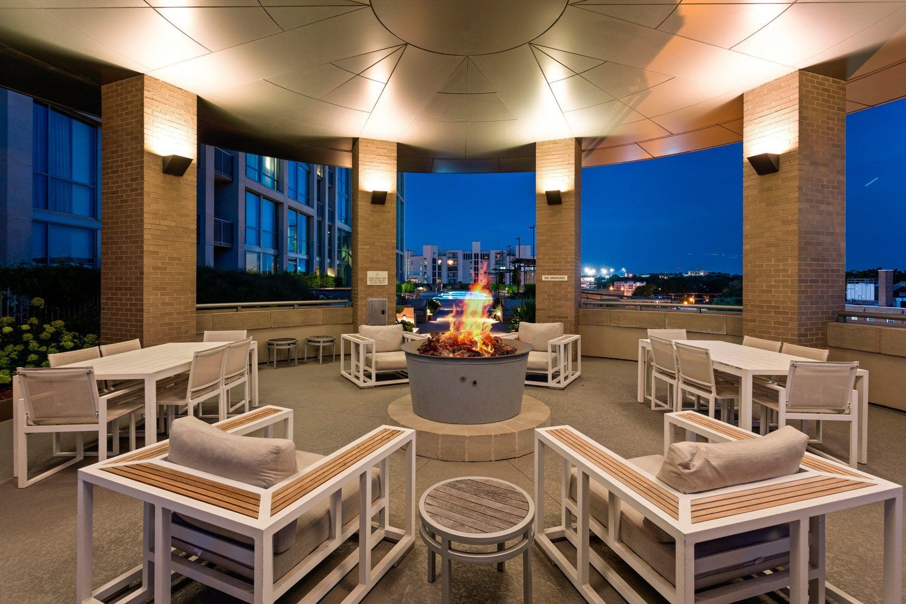 Rooftop terrace with fire pit and seating.