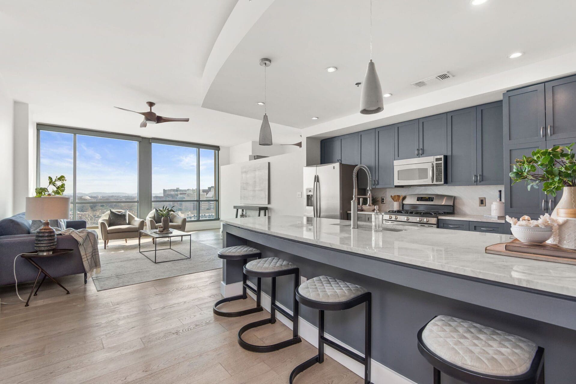 Modern kitchen and living area with view.