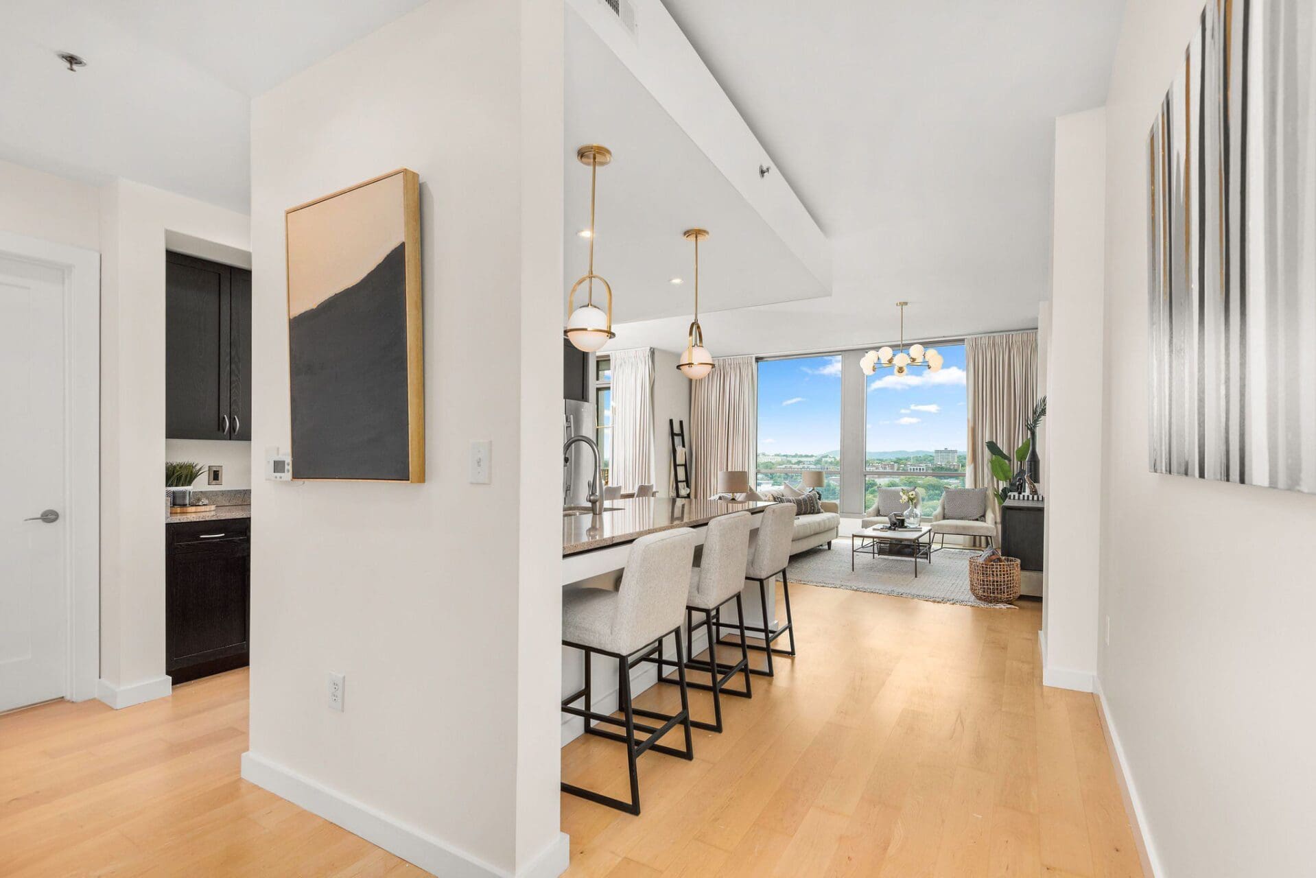 Modern kitchen and living room with view.