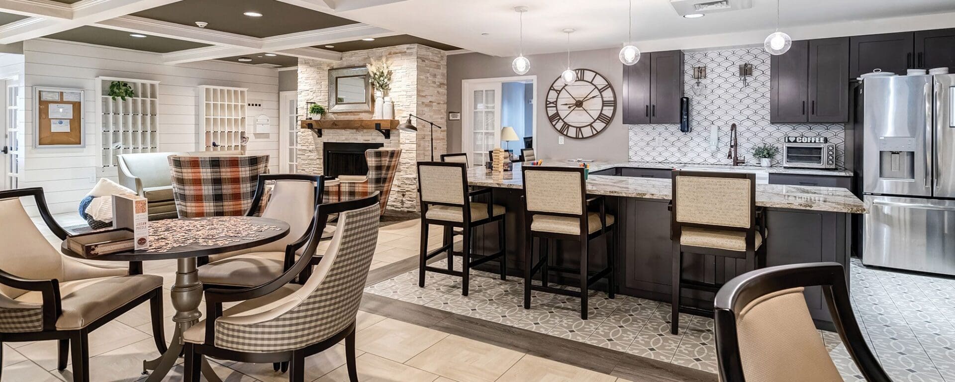 Modern kitchen and dining area with seating.