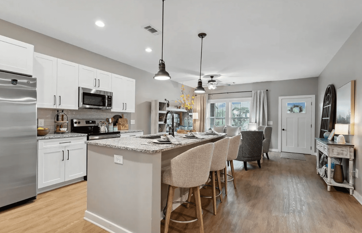 Modern kitchen and dining area with island.