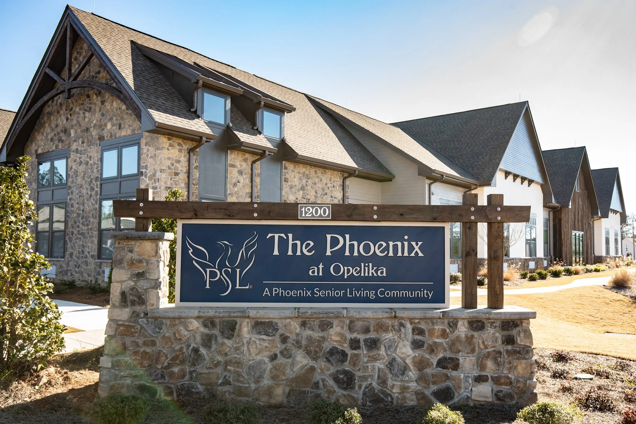 Stone building with "The Phoenix at Opelika" sign.