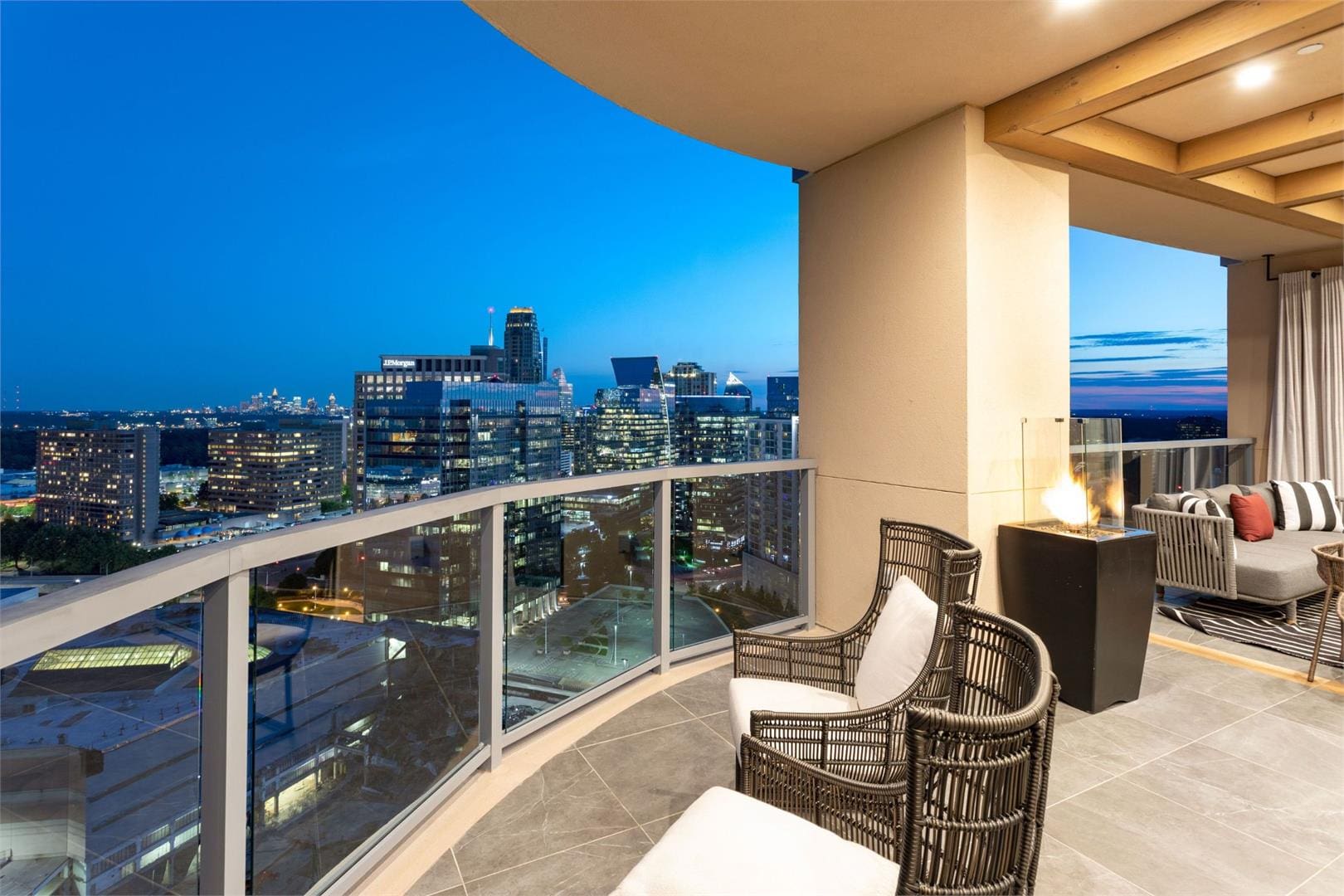 Modern balcony overlooking city skyline at night.