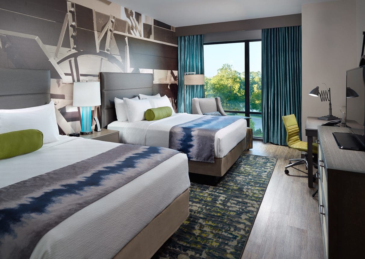 Modern hotel room with two beds.