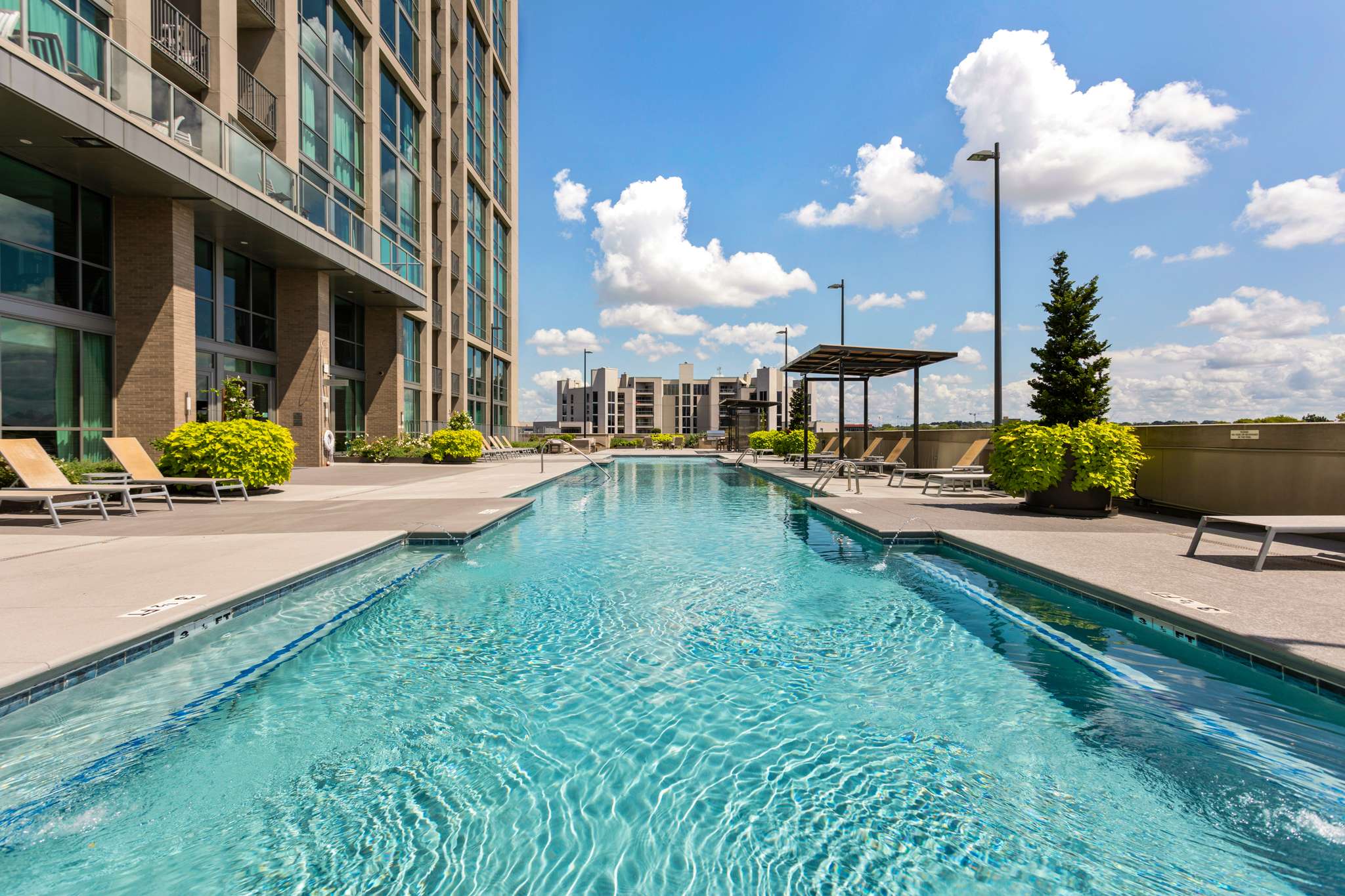Rooftop pool with cityscape in background.