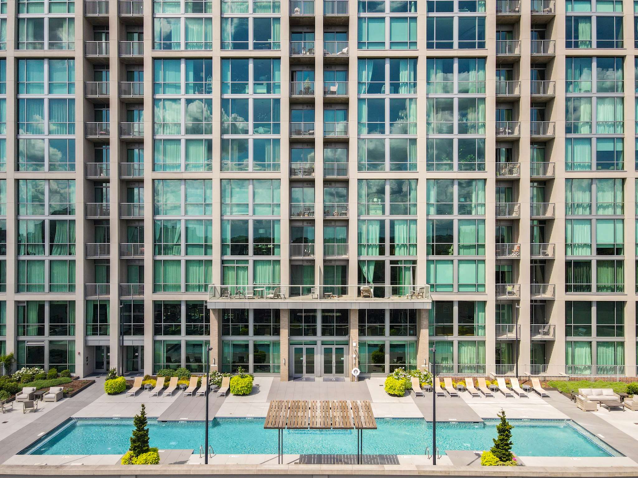 Modern apartment building with outdoor pool.