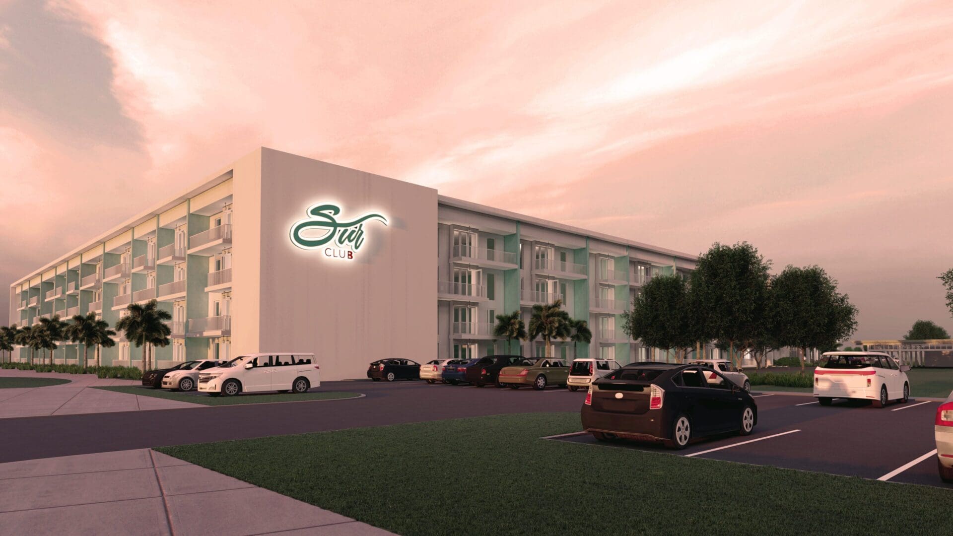 Modern hotel with parking at sunset.