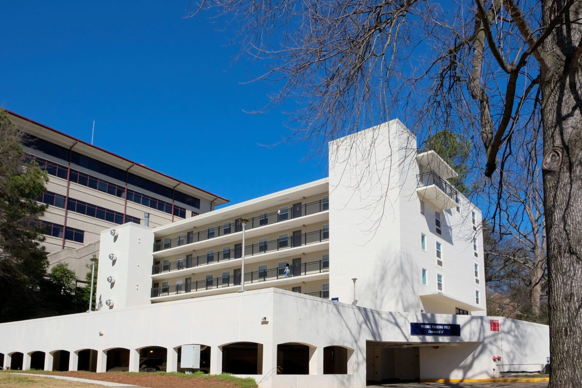 White building with balconies under clear sky.