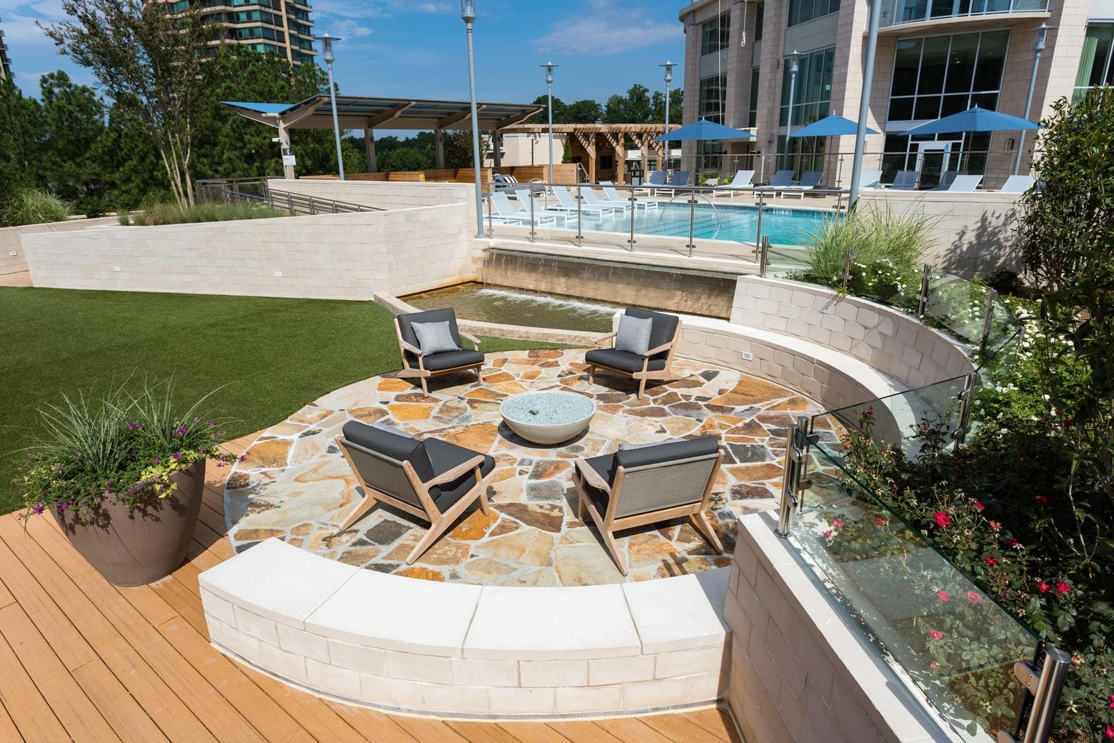 Outdoor seating area with chairs and fire pit.