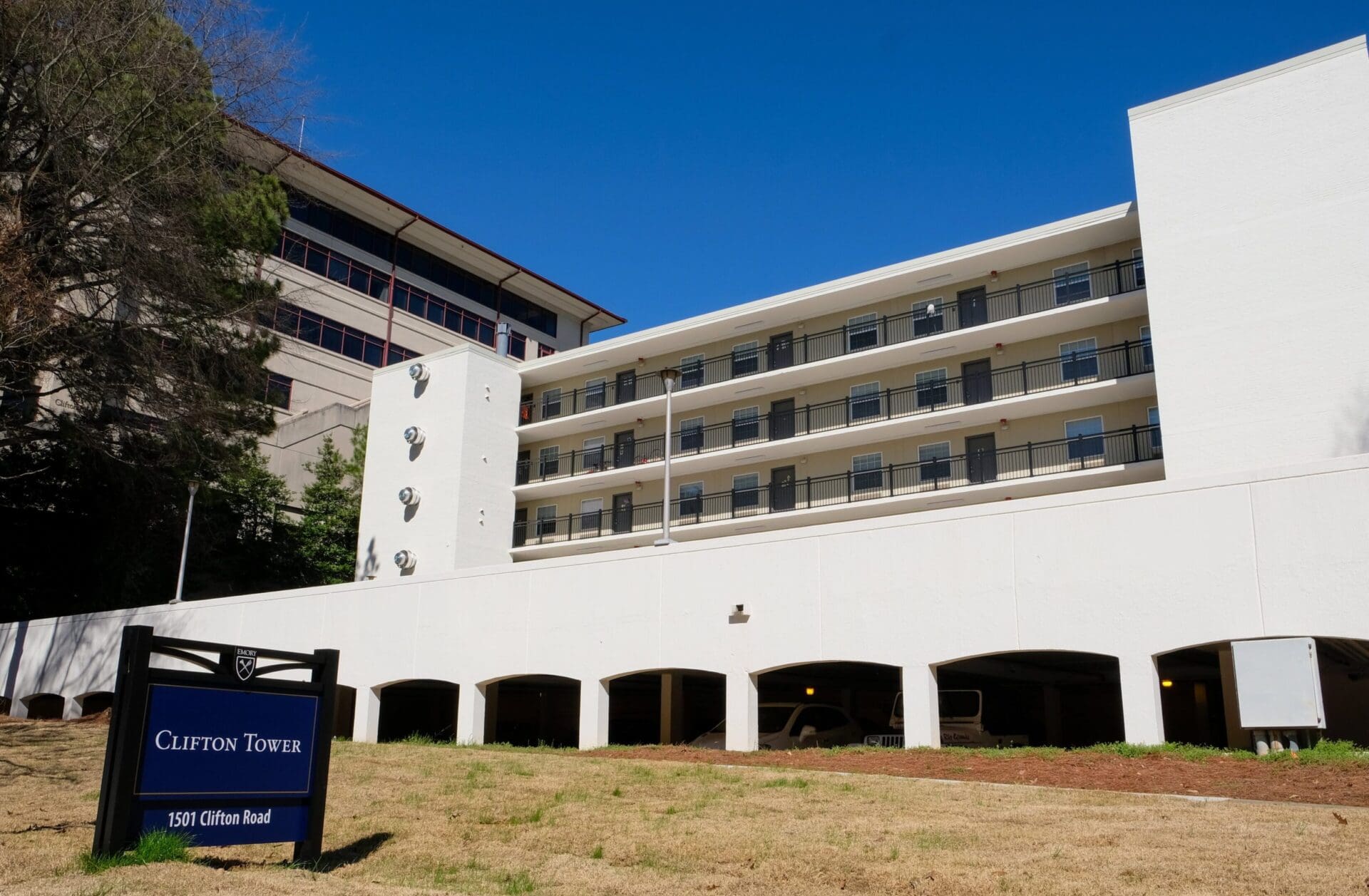 White multi-story building with Clifton Tower sign.