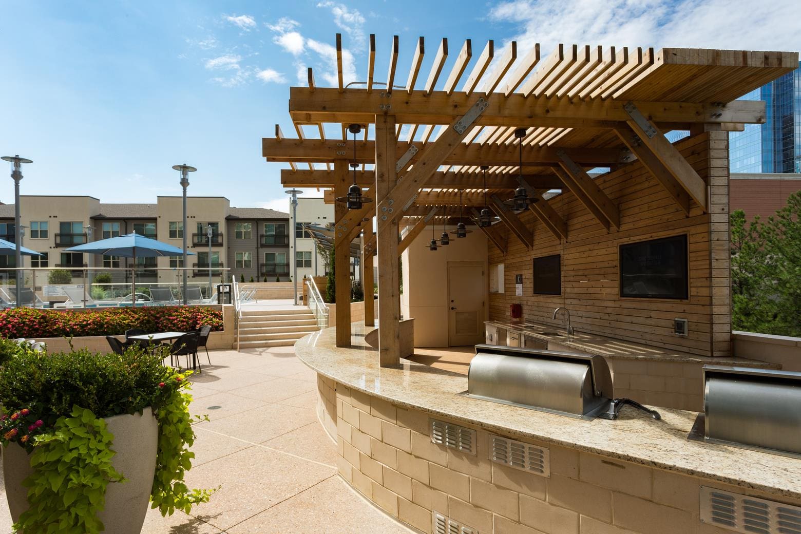 Outdoor patio with pergola and barbecue.