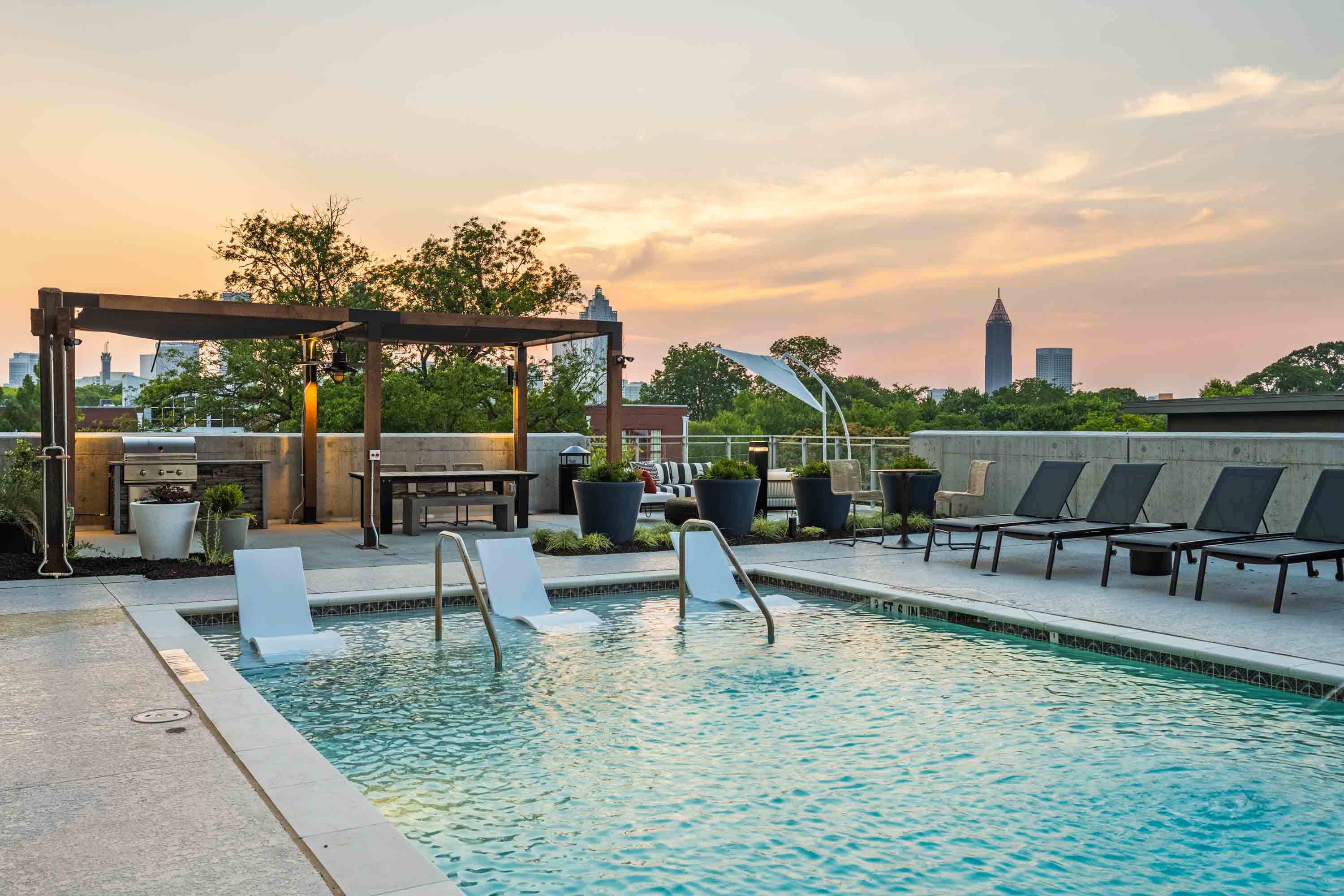 Urban rooftop pool with pergola and skyline