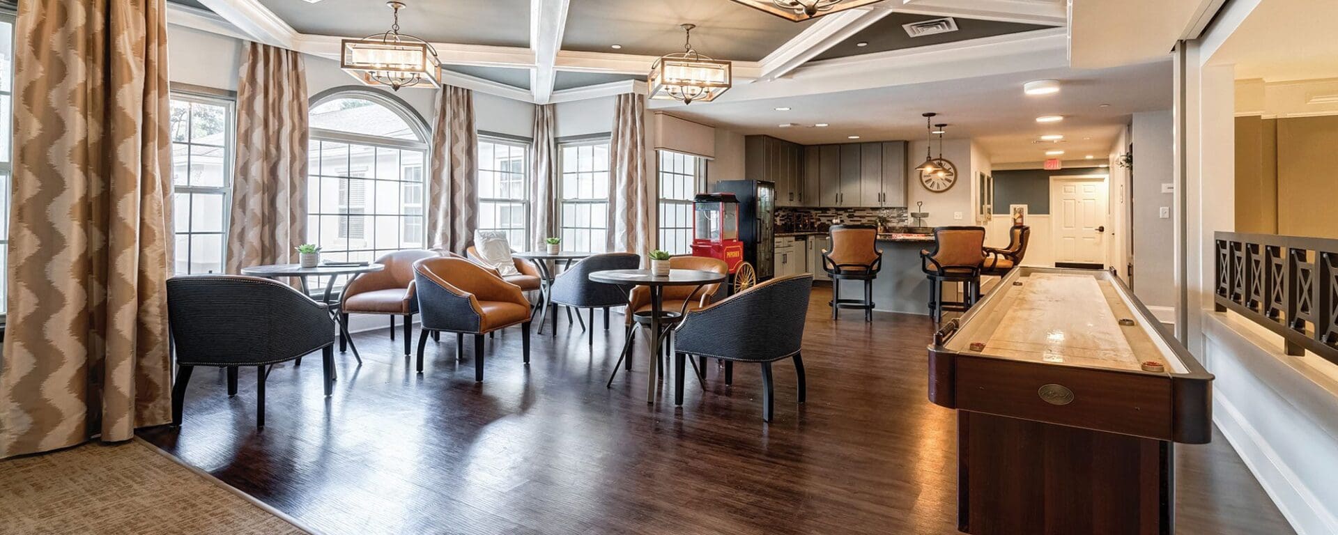 Modern communal room with tables and chairs.
