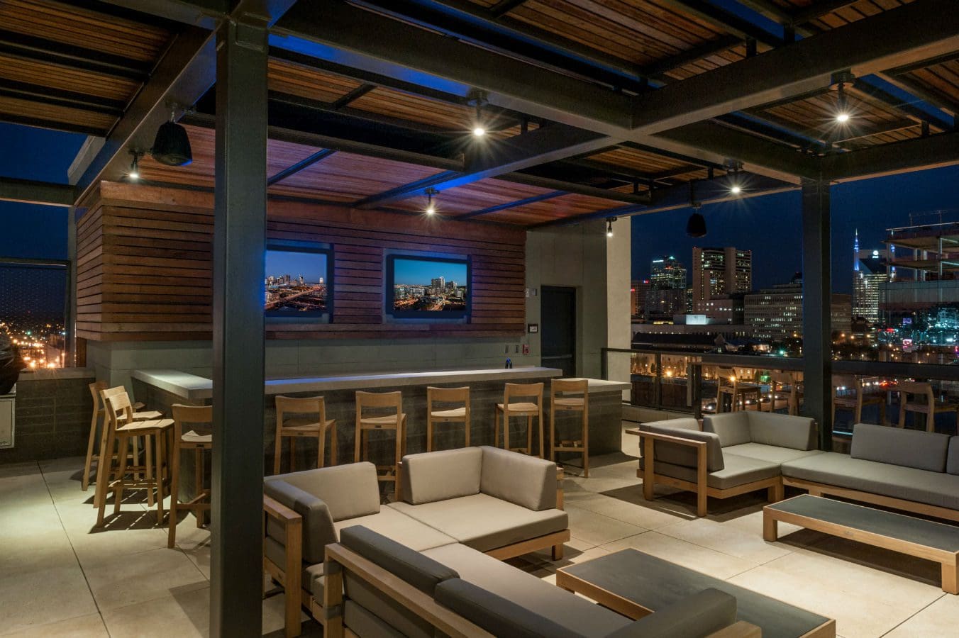 Rooftop bar with city view at night.