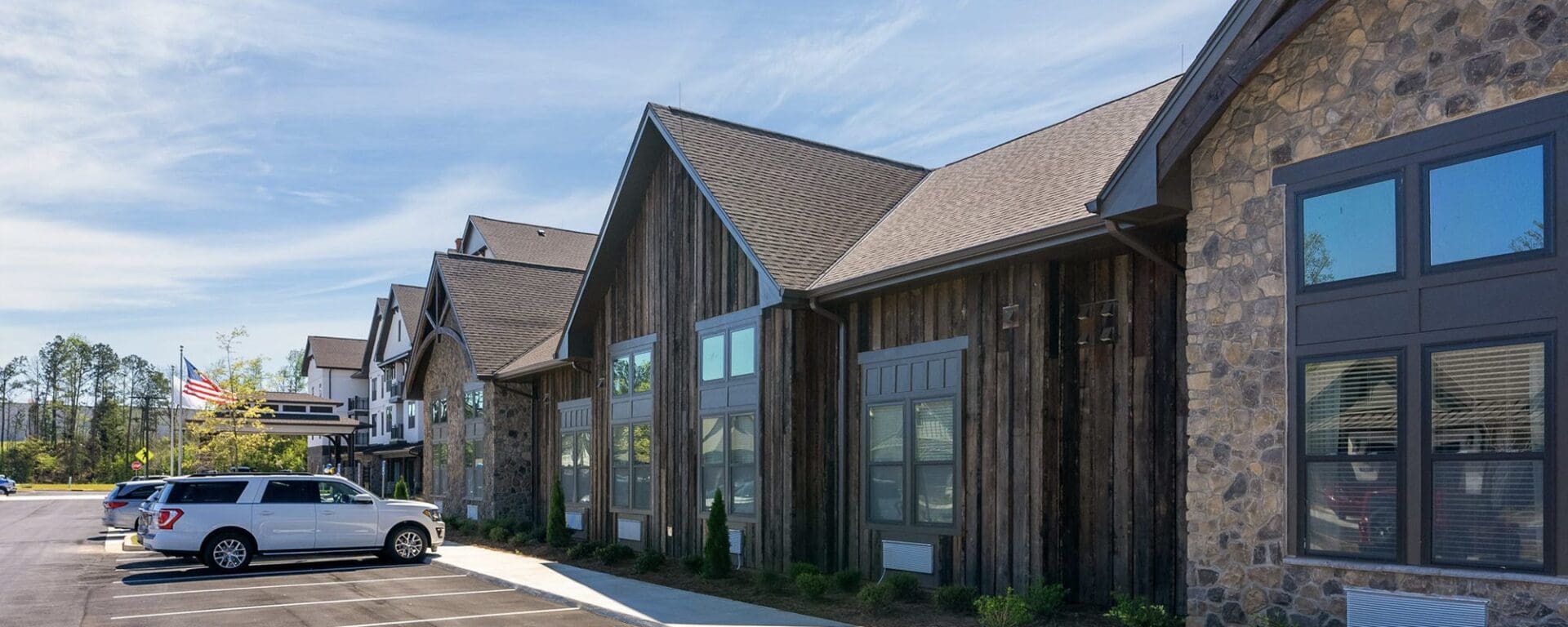 Modern building with parked cars outside.