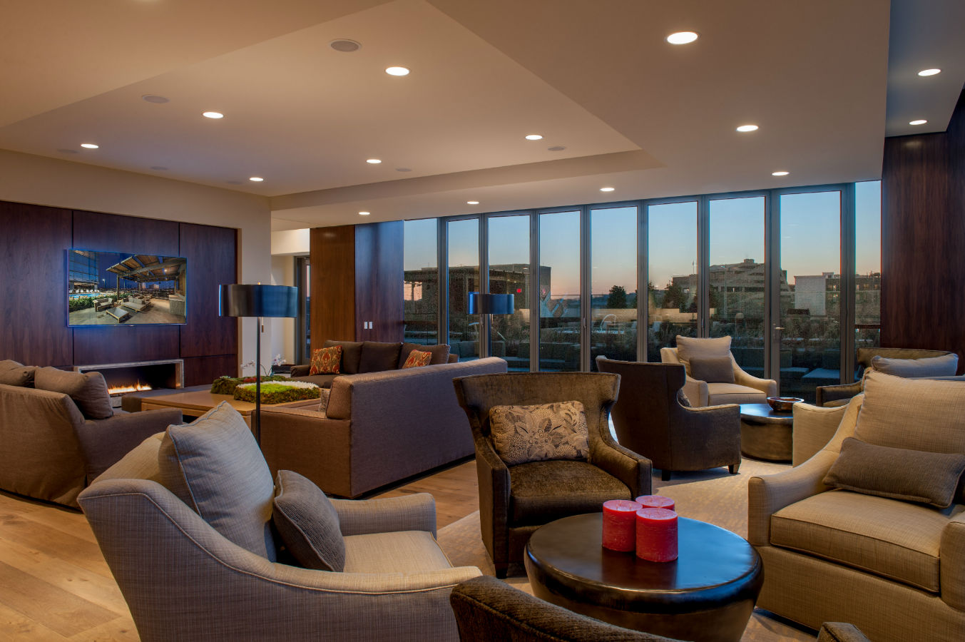 Modern lounge with city view and seating.