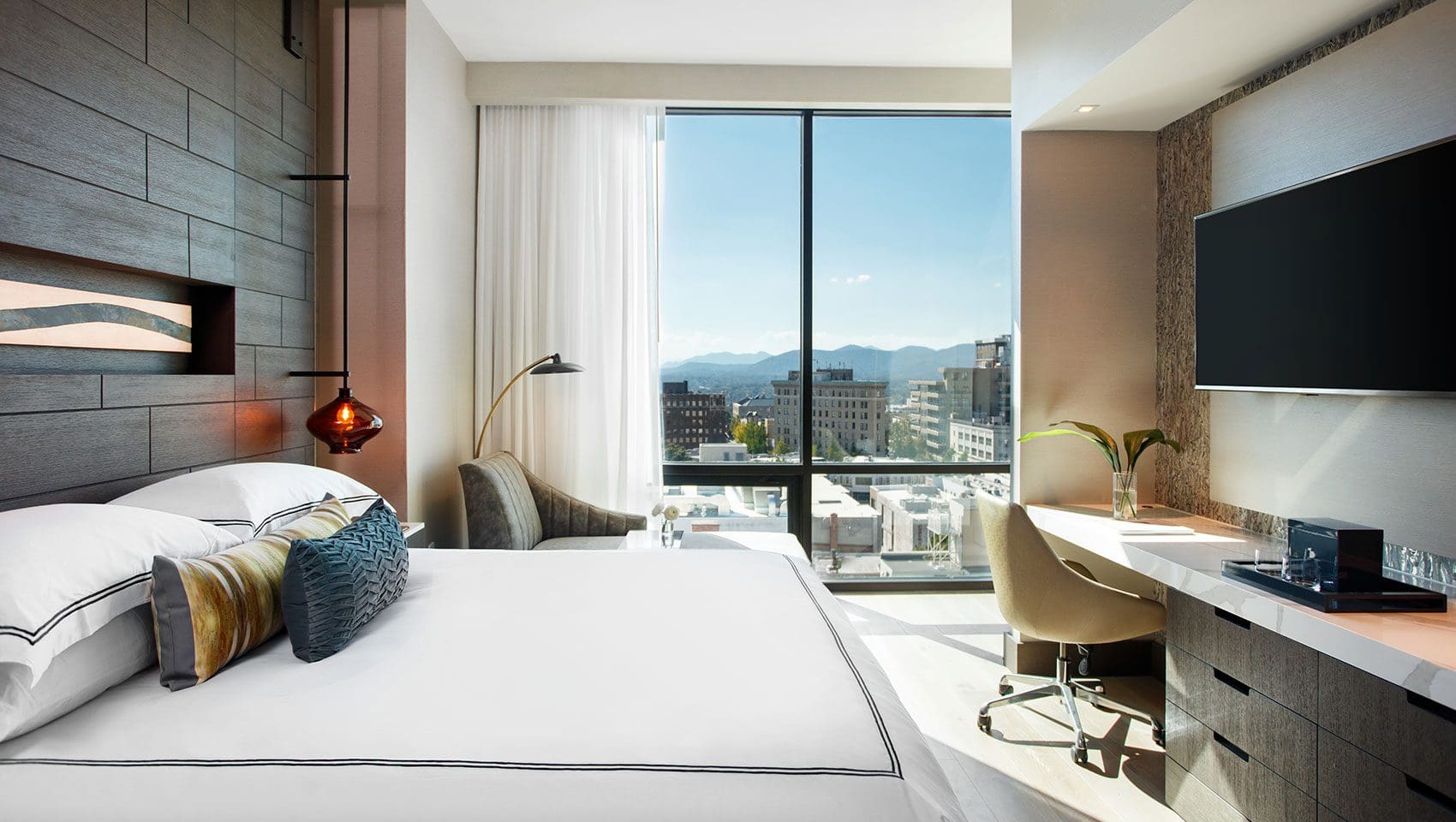 Modern hotel room with city view.