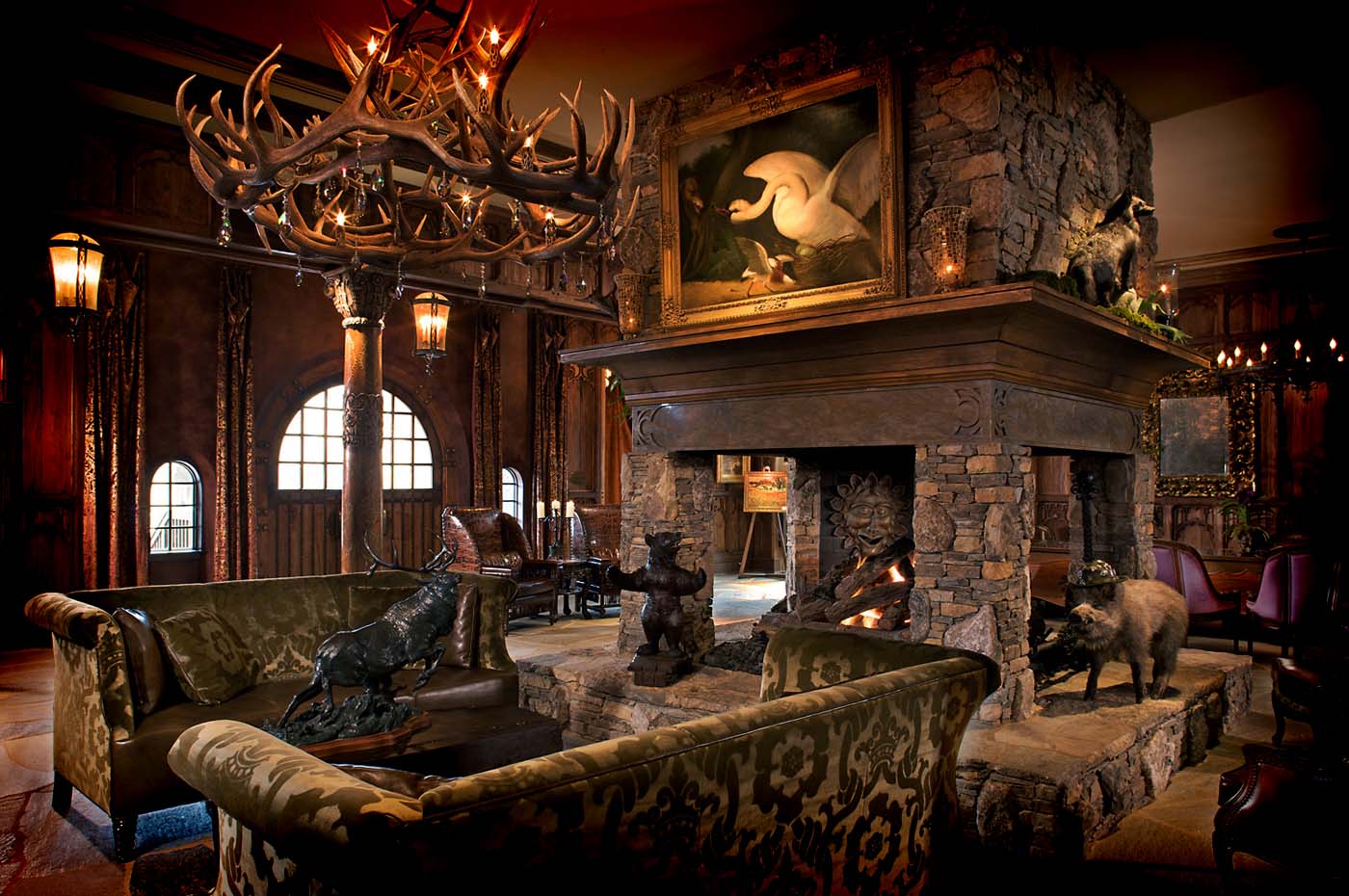 Rustic lodge interior with stone fireplace.