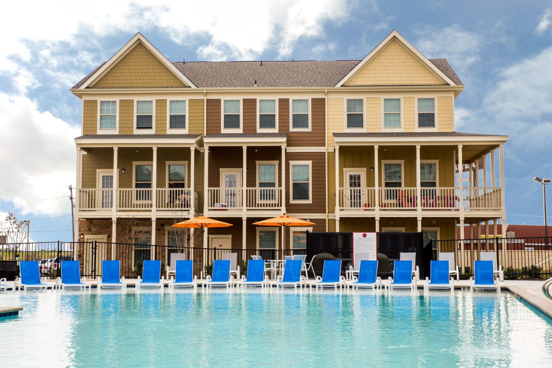 Poolside view of a large residential building.