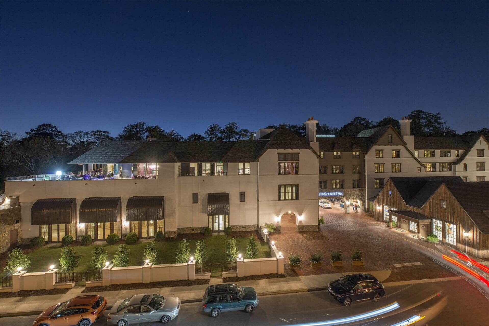 Night view of illuminated hotel and street.