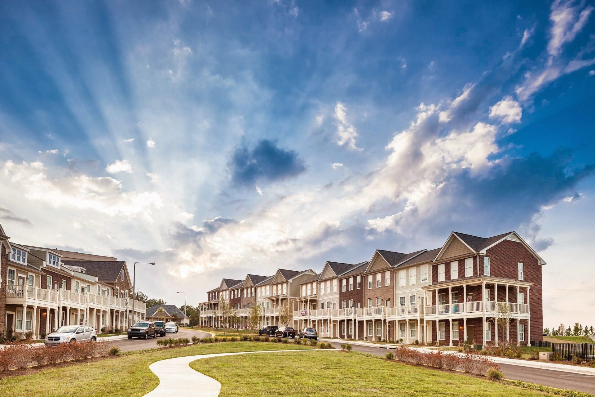 Row of houses under dramatic sky.