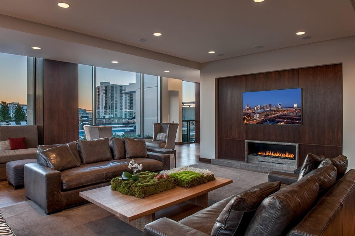 Modern living room with leather sofas and fireplace