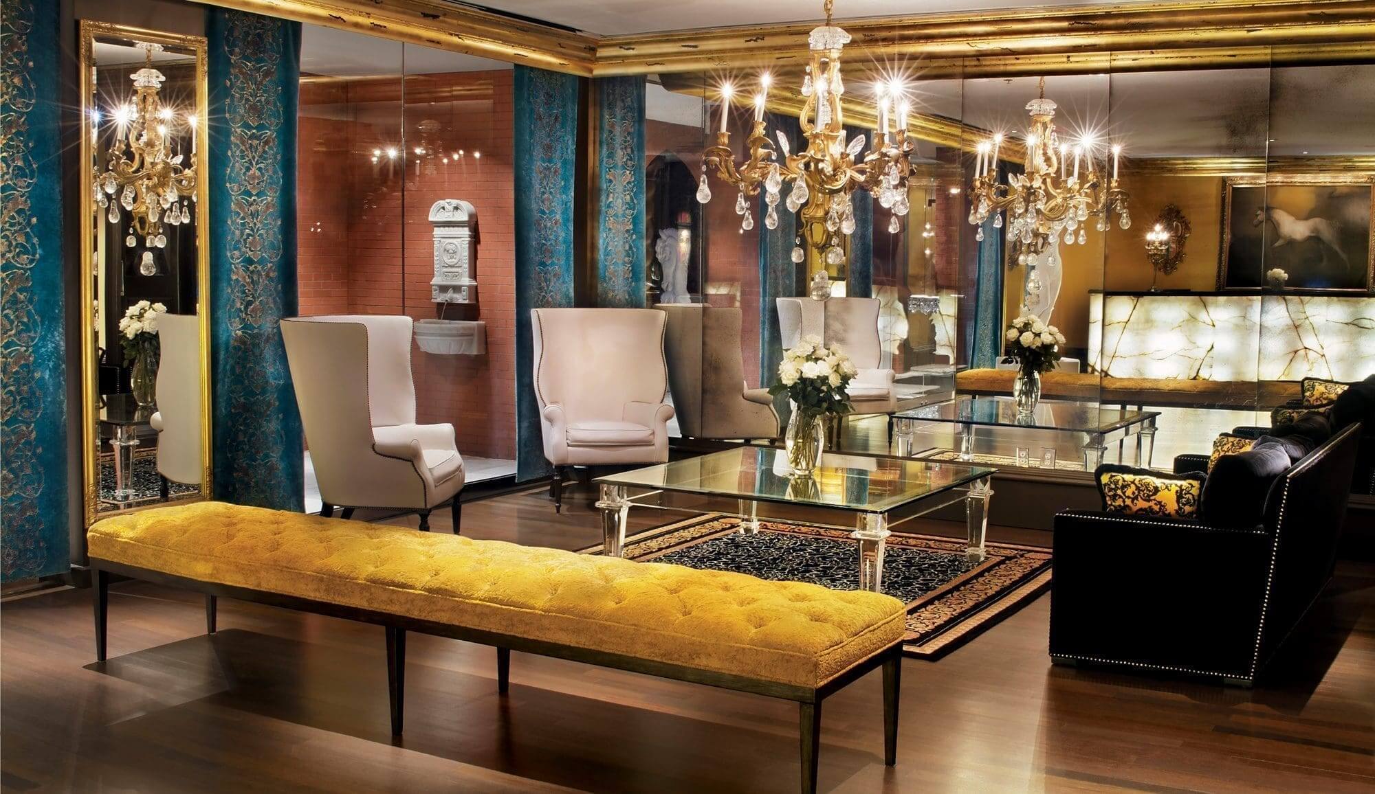 Elegant lounge with chandeliers and mirrored walls.