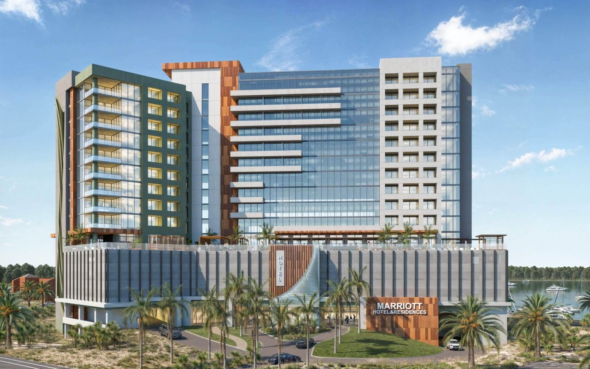 Modern hotel building with palm trees outside.