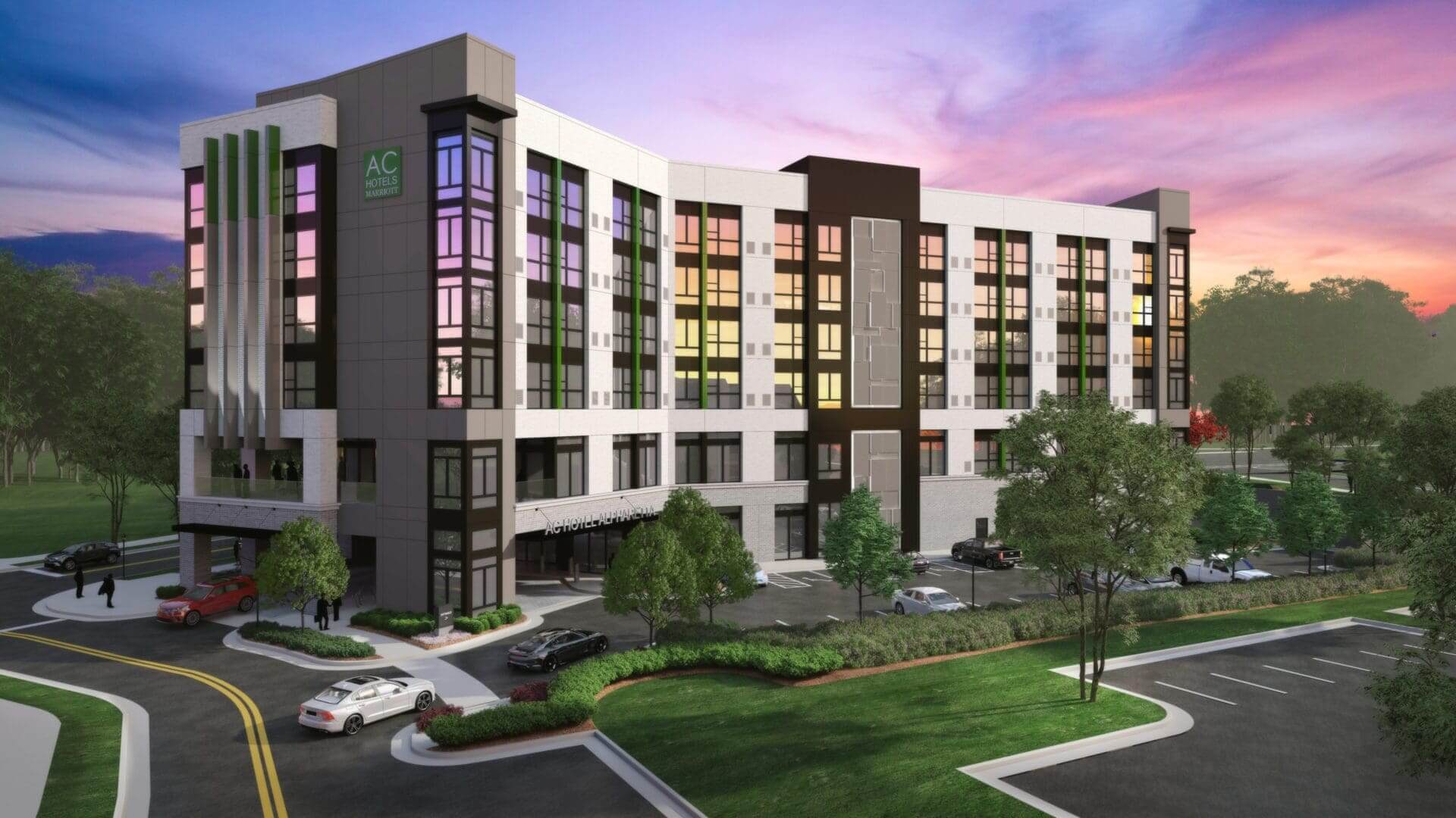 Modern hotel building with sunset sky.