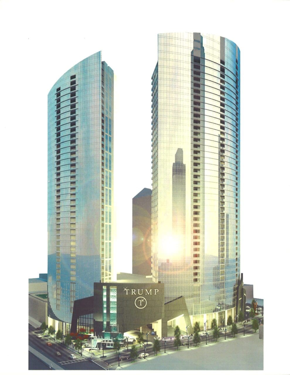 Two tall modern glass skyscrapers at sunset.