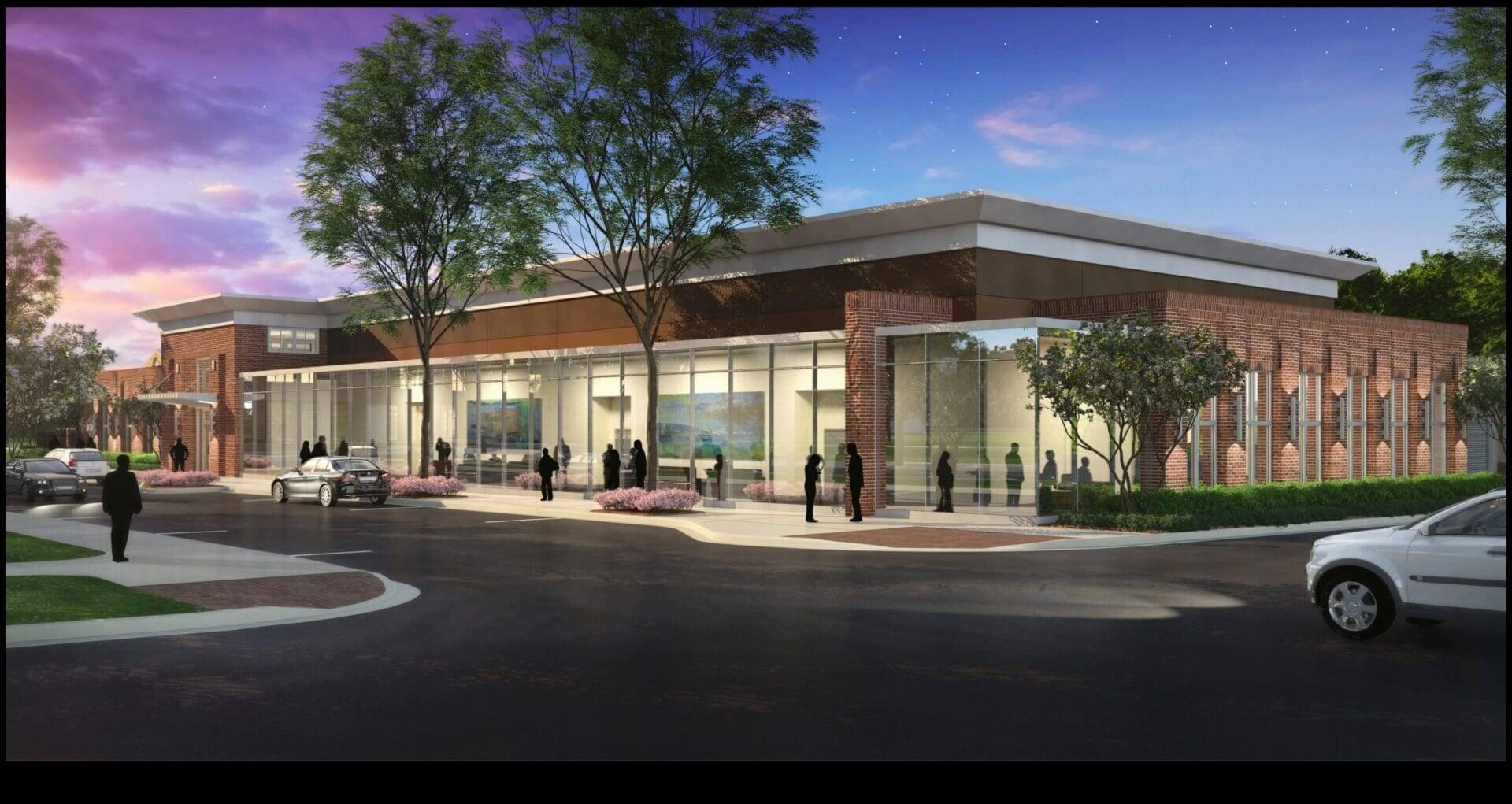 Modern building exterior with people and cars.