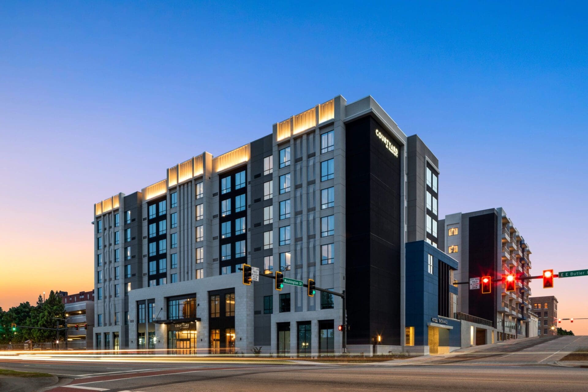 Modern hotel building at sunset intersection.