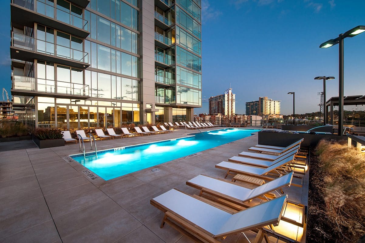 Modern apartment building with outdoor swimming pool.