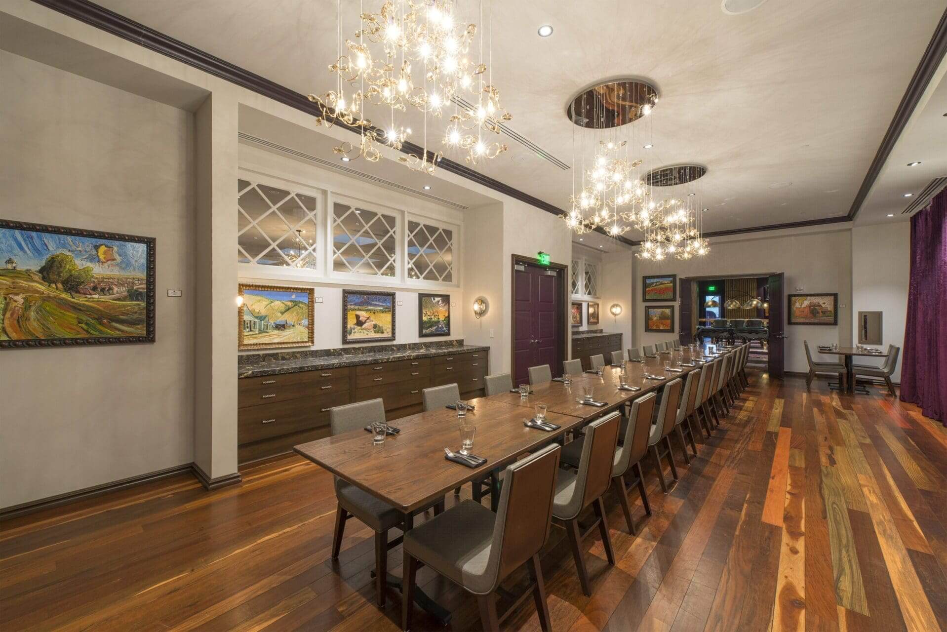 Elegant dining room with long wooden table.